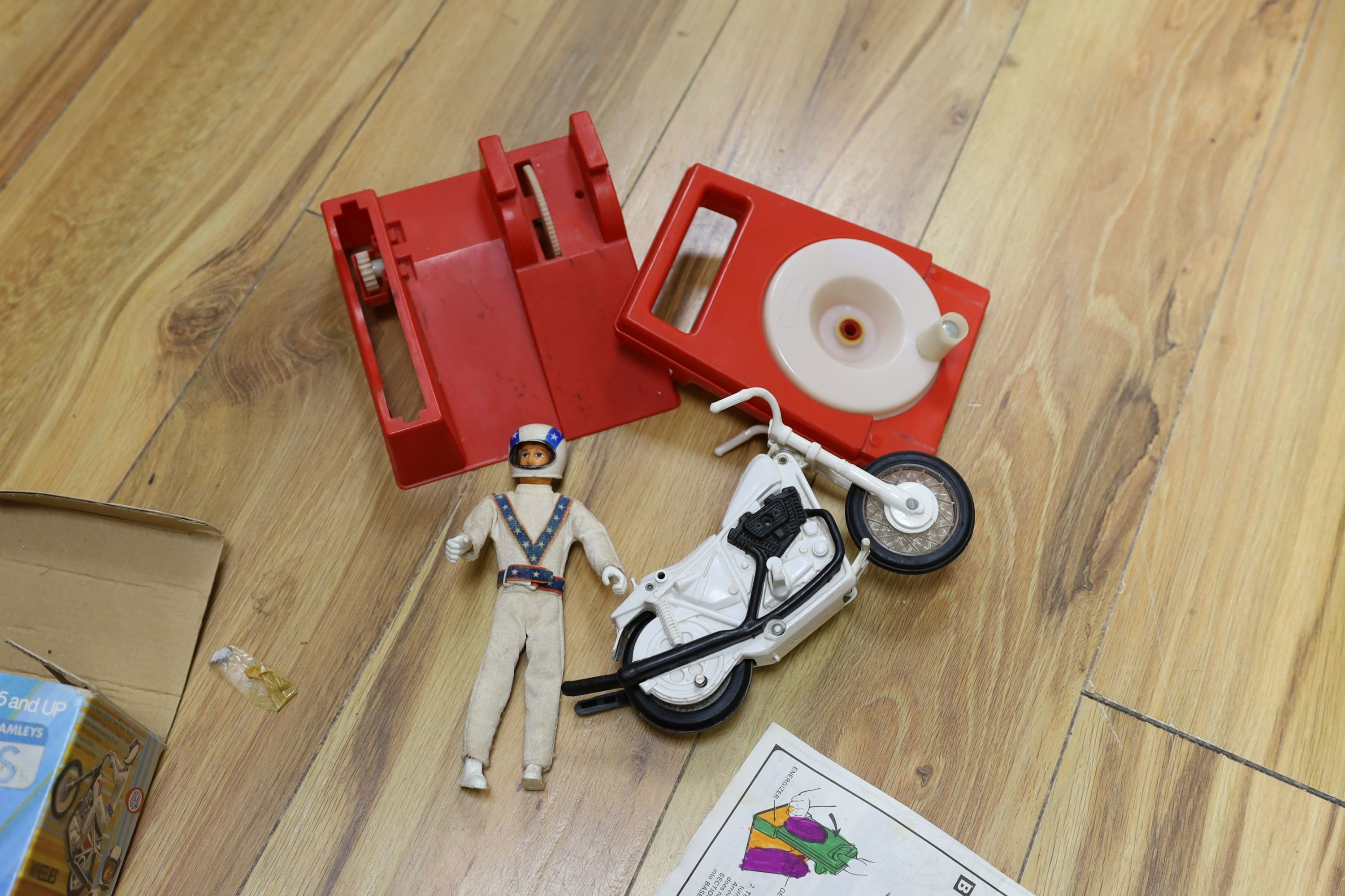 A Denys Fisher Superman, rare in original box, another unboxed, a Unigate milk float with bottles, and a boxed Evel Knievel Stunt Cycle